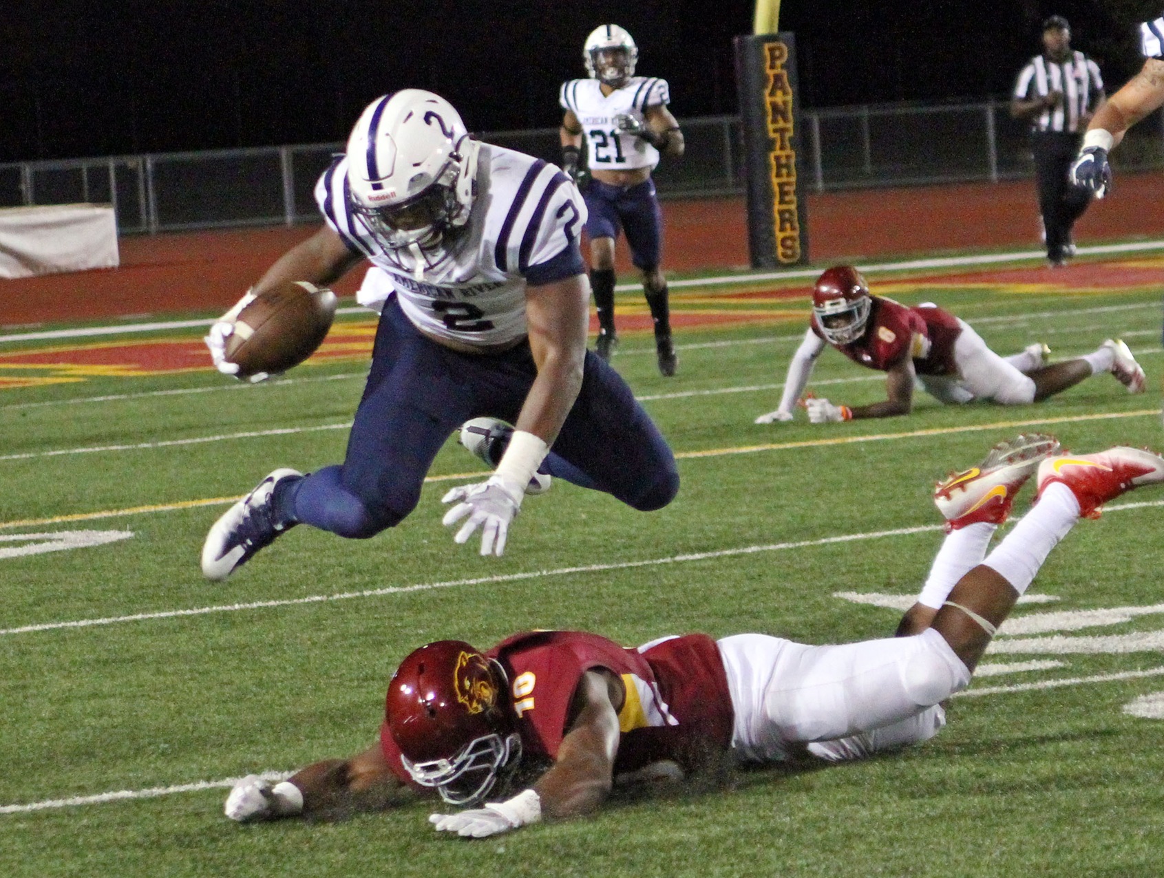 Lenny Nelson hurdling over a SCC player on a rebound.